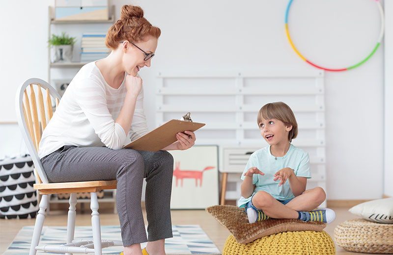 student psychologist with child in work room