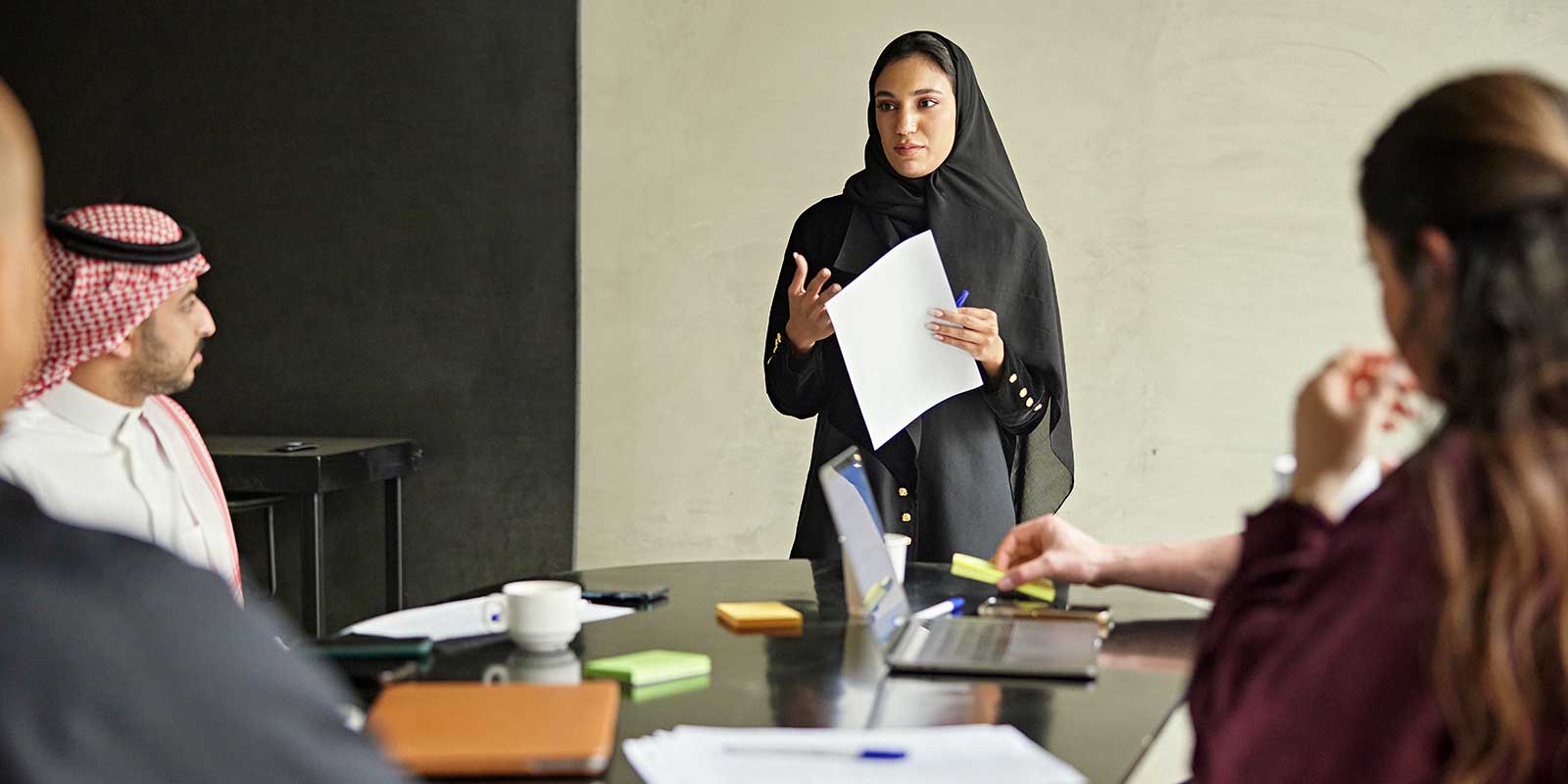 teacher in hijab speaking to classroom