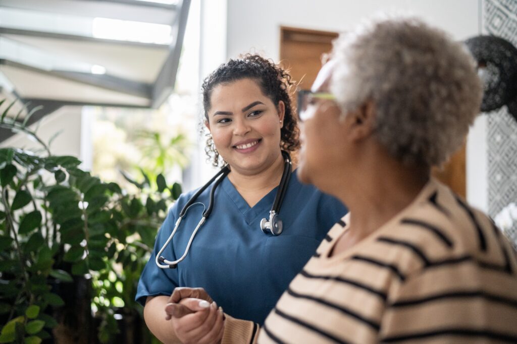 BSN student holding hand of elderly patient