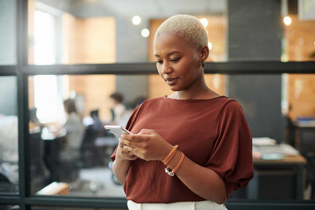 Digital marketing professional reviewing social media on phone